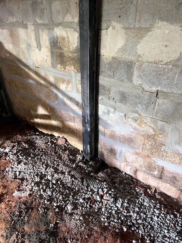 Steel wall beam installed along a block basement wall